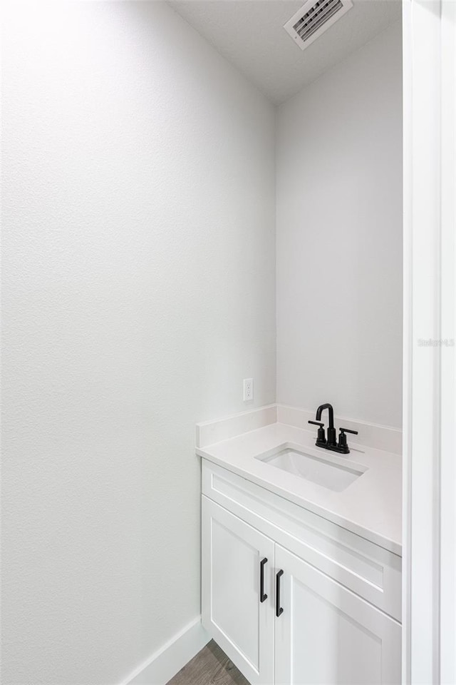 bathroom with vanity and hardwood / wood-style flooring