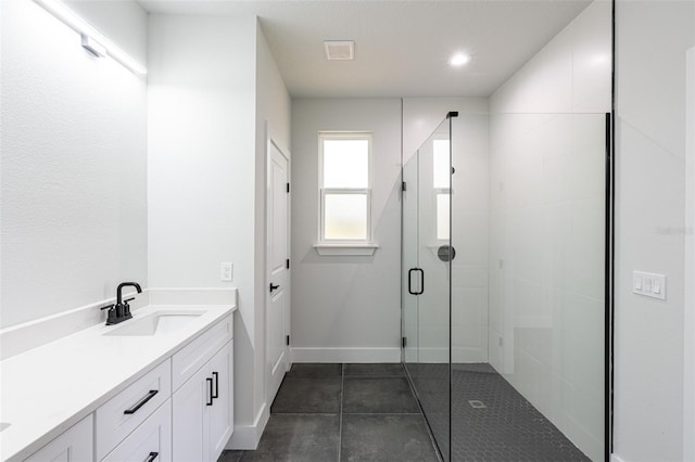 bathroom with vanity, tile patterned floors, and walk in shower