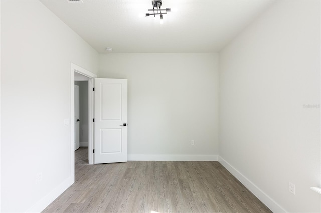 empty room with light hardwood / wood-style flooring