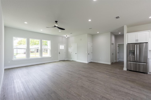 unfurnished living room with ceiling fan and wood-type flooring