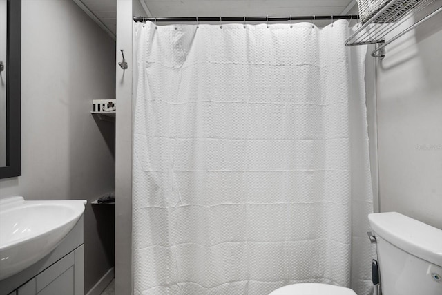 bathroom featuring vanity, toilet, and walk in shower