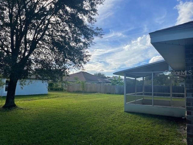 view of yard with a sunroom