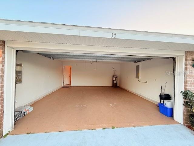 garage featuring electric water heater and electric panel