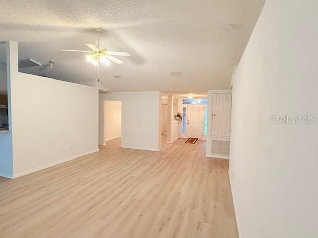 unfurnished living room with a textured ceiling, light hardwood / wood-style flooring, and ceiling fan