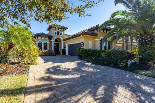 mediterranean / spanish house with a garage