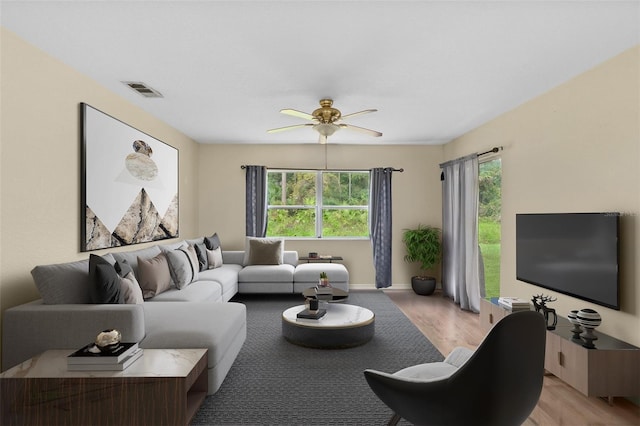 living room featuring light hardwood / wood-style floors, plenty of natural light, and ceiling fan