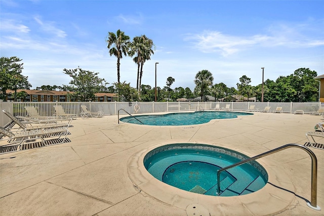 view of pool with a community hot tub and a patio