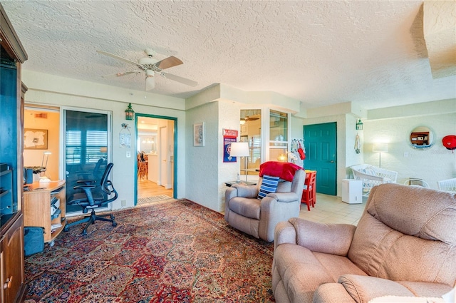 living room with ceiling fan, light hardwood / wood-style floors, and a textured ceiling