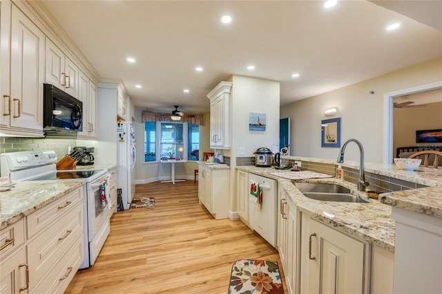 kitchen featuring ceiling fan, sink, light stone counters, light hardwood / wood-style floors, and white appliances