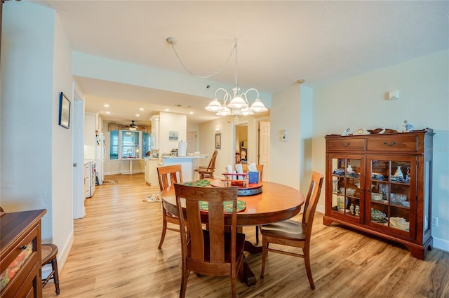 dining room with a chandelier and light hardwood / wood-style flooring