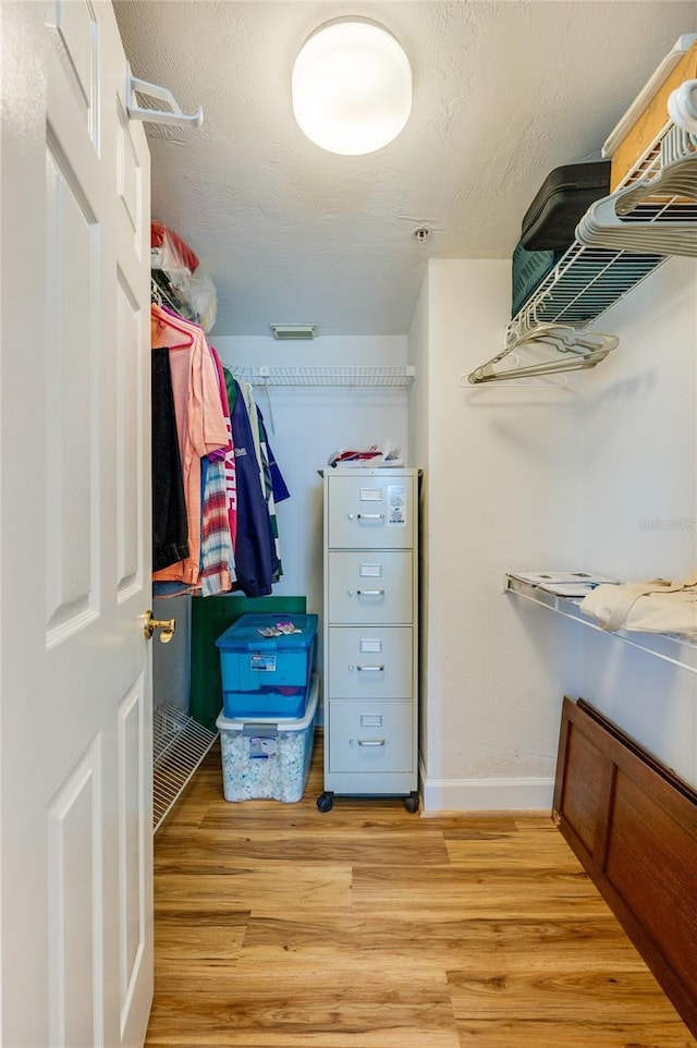 spacious closet featuring light hardwood / wood-style floors