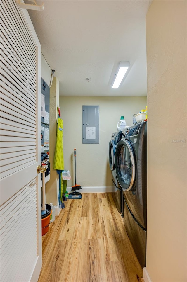 laundry room with hardwood / wood-style flooring, separate washer and dryer, and electric panel