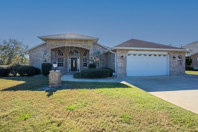 single story home featuring a front yard and a garage