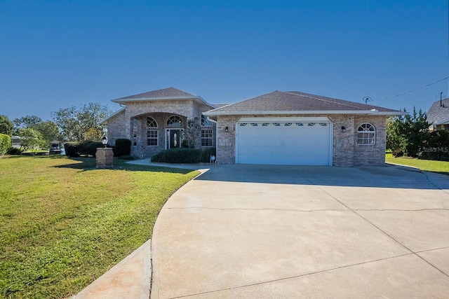 view of front of house with a front yard and a garage