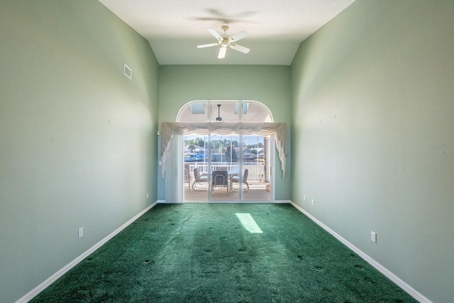 unfurnished room with ceiling fan, lofted ceiling, and carpet floors