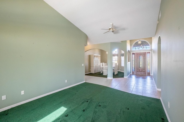 entrance foyer with ceiling fan, light colored carpet, and lofted ceiling