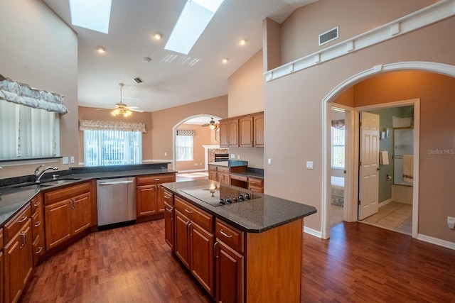 kitchen featuring dishwasher, a center island, dark hardwood / wood-style flooring, and ceiling fan