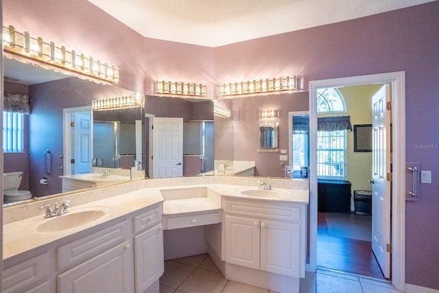 bathroom with tile patterned flooring, vanity, and toilet