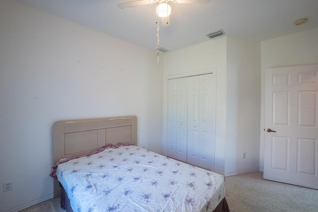 bedroom featuring ceiling fan, a closet, and carpet floors