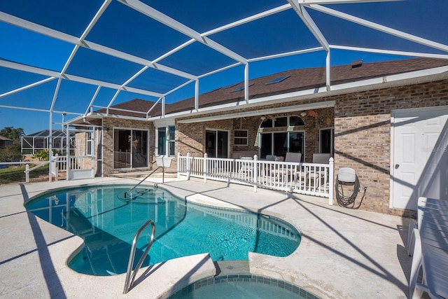 view of swimming pool with a patio area and a lanai