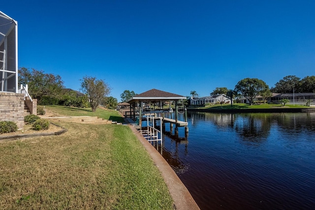 dock area featuring a yard, a water view, and glass enclosure