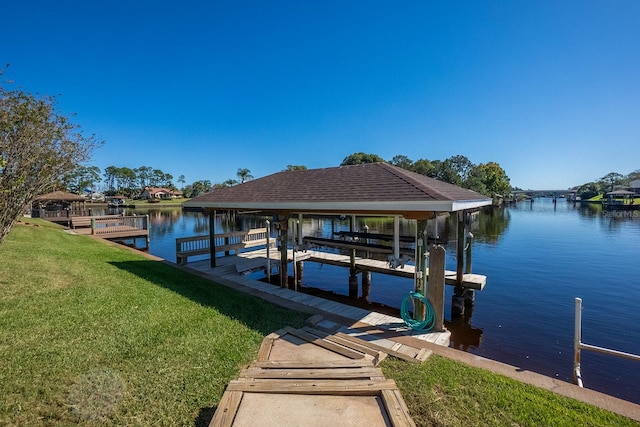 view of dock with a water view and a yard