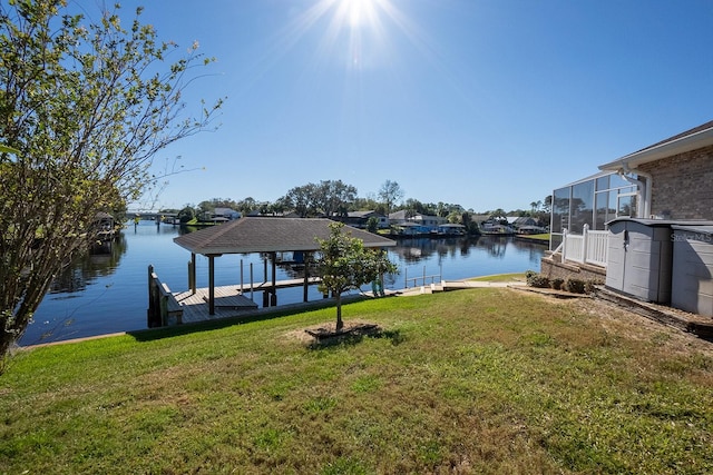 dock area with a yard and a water view