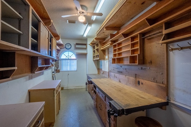 kitchen featuring ceiling fan, butcher block counters, and a textured ceiling