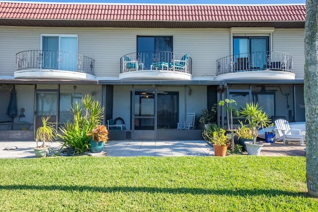 4 Ocean Palm Villa N, Flagler Beach, FL 32136 - rear view of house with a tiled roof, a balcony, and a patio area