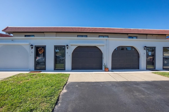 4 Ocean Palm Villa N, Flagler Beach, FL 32136 - view of front facade featuring a tiled roof, concrete driveway, and a garage