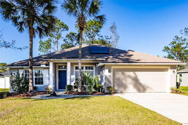 single story home featuring a garage, a front yard, and solar panels