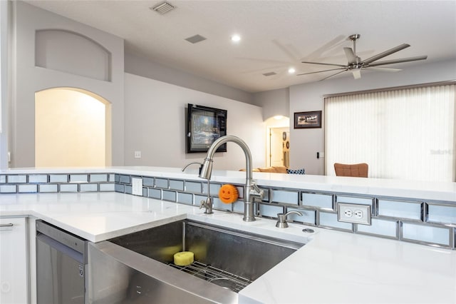 kitchen with stainless steel dishwasher, ceiling fan, and sink