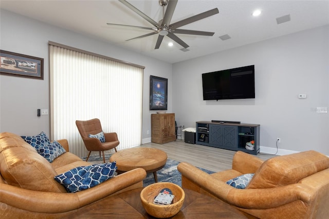 living room featuring ceiling fan and light wood-type flooring