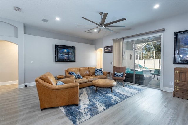 living room with light wood-type flooring and ceiling fan