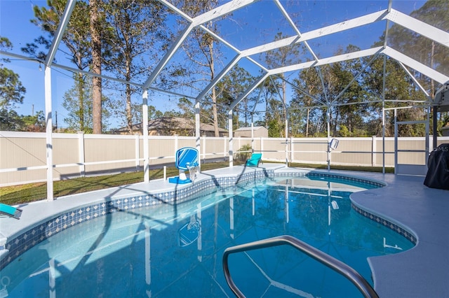 view of pool with a patio and glass enclosure