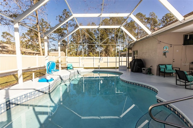 view of swimming pool featuring glass enclosure, a patio, and grilling area