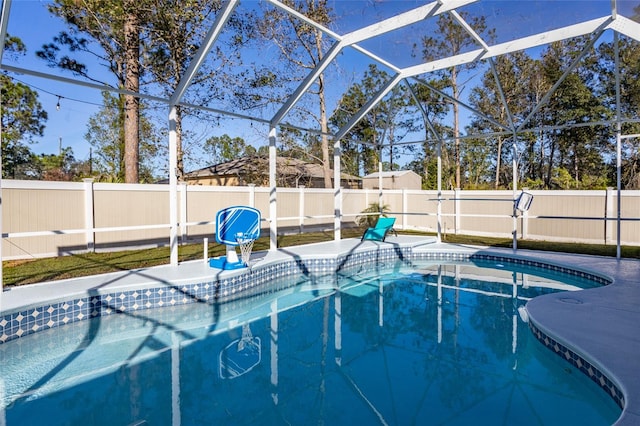 view of swimming pool featuring a lanai