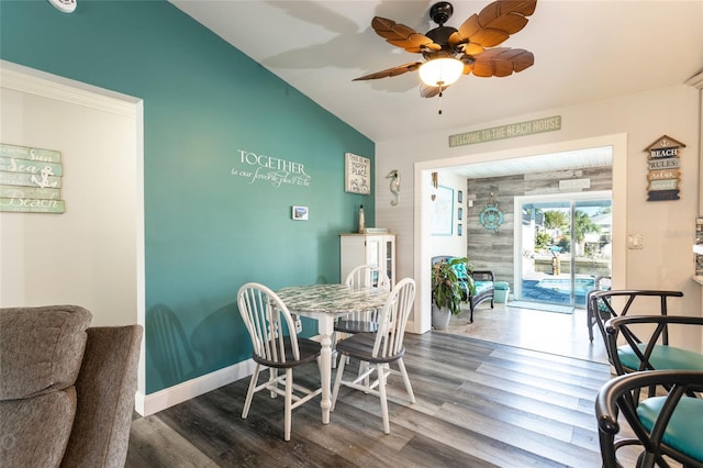 dining room with wood-type flooring, vaulted ceiling, and ceiling fan