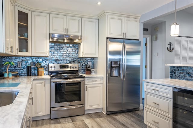 kitchen featuring backsplash, light stone counters, and stainless steel appliances