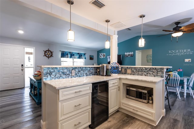 kitchen featuring tasteful backsplash, dark hardwood / wood-style flooring, and decorative light fixtures