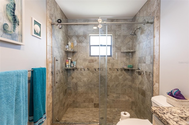 bathroom featuring vanity, toilet, and walk in shower