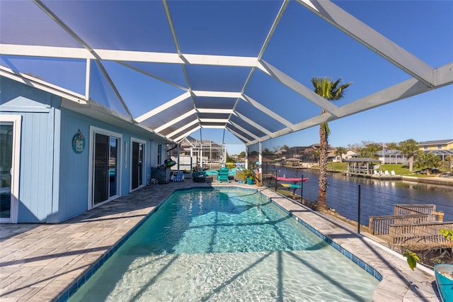 view of pool featuring a lanai, a patio area, and a water view