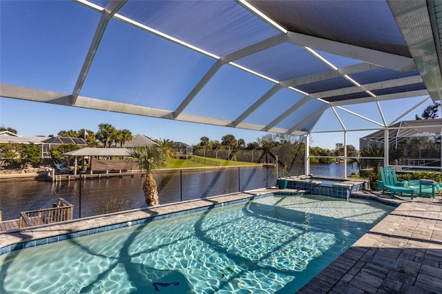 view of swimming pool featuring a lanai, a patio area, a water view, and an in ground hot tub