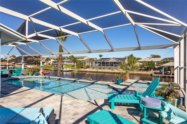 view of swimming pool with a water view, glass enclosure, and a patio area