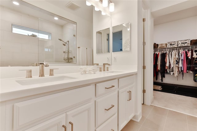 bathroom with tile patterned flooring, vanity, and an enclosed shower