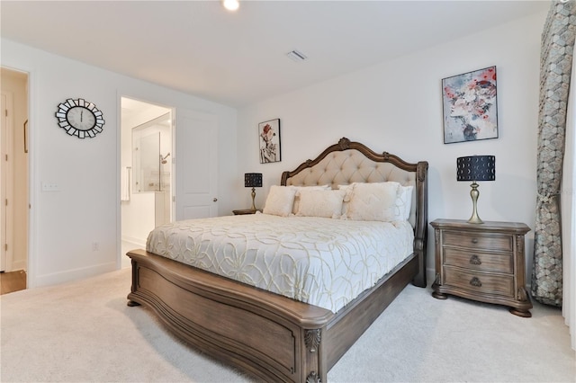 bedroom featuring ensuite bath and carpet floors