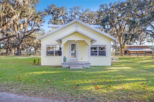 bungalow-style home featuring a front yard