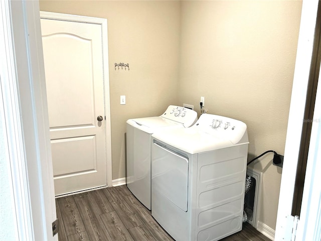 washroom with washer and clothes dryer and dark hardwood / wood-style flooring