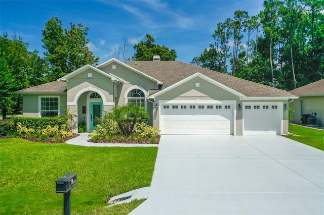 ranch-style house featuring a garage and a front lawn