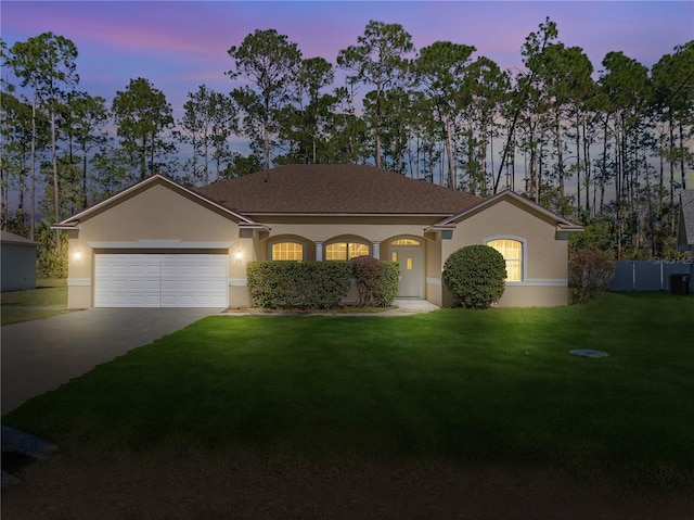 single story home featuring a yard and a garage